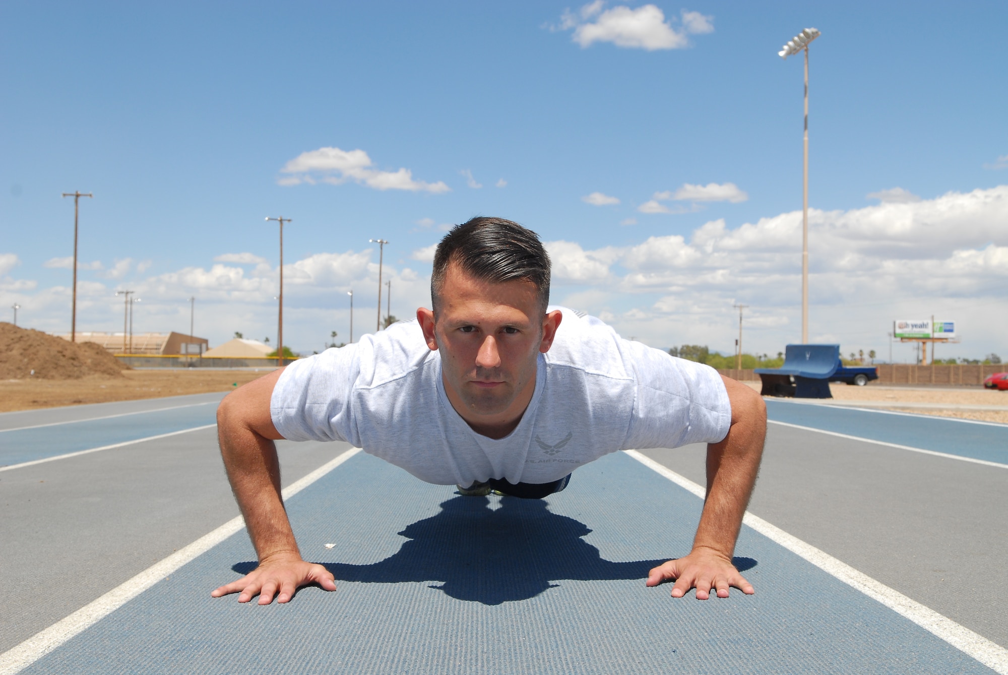 Senior Airman Nicholas Liuzzi, 56th Aerospace Medicine Squadron public health technician, performs a pushup at the Luke Air Force Base track April 17. Pushups help in strengthening abdominal muscles. Core muscles engage while helping to support the body during a pushup. (U.S. Air Force photo/Airman 1st Class Grace Lee)