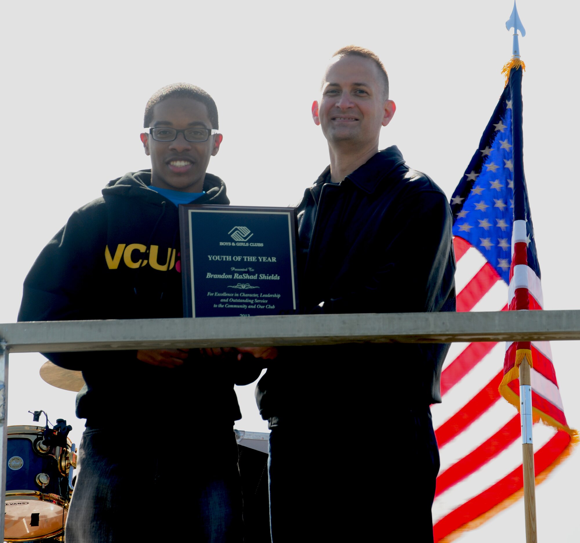 Col. Bill Knight, 11th Wing/Joint Base Andrews commander, presents Brandon Shields, JBA Youth Program member, with the Youth of the Year award April 20, 2013, at Joint Base Andrews, Md., for demonstrating leadership and service in the community and adhering to high moral standards. Shields was honored during the 2013 Family Fest Rodeo.