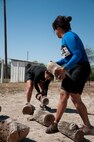 Denise Rubio puts down a log in the Del Rio Battle on the Border Mud Crawl at the Val Verde County Fairgrounds April 20, 2013. The log carry, one of several obstacles at the mud crawl, had participants carry heavy logs from one point to another. (U.S. Air Force photo/Airman 1st Class Jimmie D. Pike)