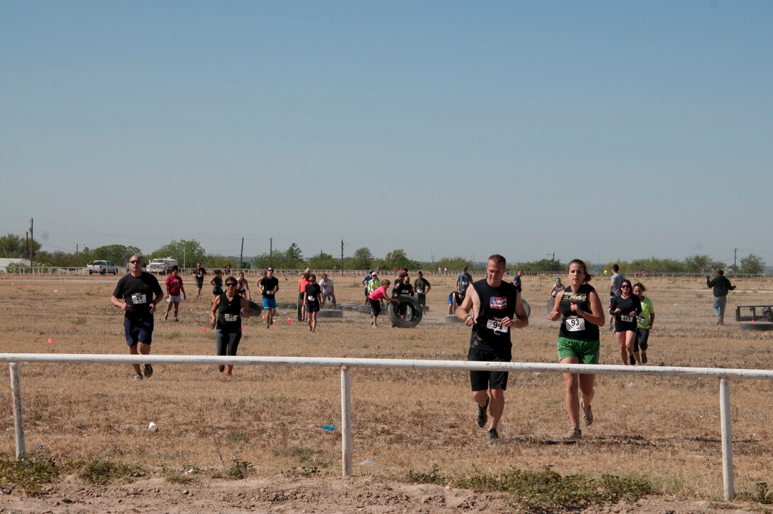 Participants in the Del Rio Battle on the Border Mud Crawl run from one obstacle to another at the Val Verde County Fairgrounds April 20, 2013. The mud crawl was a two-mile obstacle course that included various challenges for all involved. (U.S. Air Force photo/Airman 1st Class Jimmie D. Pike)