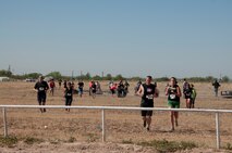 Participants in the Del Rio Battle on the Border Mud Crawl run from one obstacle to another at the Val Verde County Fairgrounds April 20, 2013. The mud crawl was a two-mile obstacle course that included various challenges for all involved. (U.S. Air Force photo/Airman 1st Class Jimmie D. Pike)