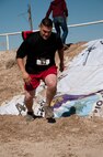 Ricardo Delgado completes the first obstacle in Del Rio’s first Battle on the Border Mud Crawl at the Val Verde County Fairgrounds April 20, 2013. The Mud Crawl was a two-mile obstacle course which included a mud slide, tire run, mud mountain and mud pit. (U.S. Air Force photo/Airman 1st Class Jimmie D. Pike)