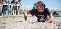 Christina Bishop finishes a mud pit obstacle in Del Rio’s first Battle on the Border Mud Crawl at the Val Verde County Fairgrounds April 20, 2013. The Mud Crawl was followed by music from local bands, food, arts and crafts vendors, games for kids, a car show and various other activities in which Team XL members could get involved. (U.S. Air Force photo/Airman 1st Class John D. Partlow)