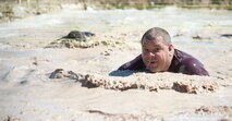 A participant in Del Rio’s first Battle on the Border Mud Crawl emerges from a mud pit at the Val Verde County Fairgrounds April 20, 2013. The Mud Crawl was followed by music from local bands, food, arts and crafts vendors, games for kids, a car show and various other activities. (U.S. Air Force photo/Airman 1st Class John D. Partlow)
