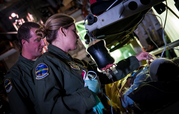 Maj. Roseann Teckman and 2nd Lt. Jason Foster, 315th Aeromedical Evacuation Squadron flight nurses, put medical equipment on an actor before shooting a scene for an Army Wives episode aboard a C-17 Globemaster III April 23, 2013, at Joint Base Charleston – Air Base, S.C. Army Wives tells the story of four women and one man who are brought together by their common bond - they all have military spouses. The series is based on the book "Under the Sabers: The Unwritten Code of Army Wives" by Tanya Biank and is produced by ABC Television Studio and The Mark Gordon Company. (U.S. Air Force photo/Senior Airman Dennis Sloan)