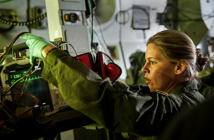 Maj. Roseann Teckman, 315th Aeromedical Evacuation Squadron flight nurse, sets up medical equipment to be used as props by her and a team of Air Force aeromedical evacuation team members during the filming of an Army Wives episode aboard a C-17 Globemaster III April 23, 2013, at Joint Base Charleston – Air Base, S.C. "Army Wives" tells the story of four women and one man who are brought together by their common bond - they all have military spouses. The series is based on the book "Under the Sabers: The Unwritten Code of Army Wives" by Tanya Biank and is produced by ABC Television Studio and The Mark Gordon Company. (U.S. Air Force photo/Senior Airman Dennis Sloan)