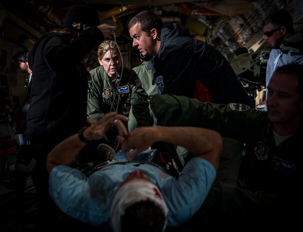 Maj. Roseann Teckman, 315th Aeromedical Evacuation Squadron flight nurse, demonstrates how a military flight nurse would care for an injured patient in a medivac situation, for the filming of an Army Wives episode April 23, 2013, at Joint Base Charleston – Air Base, S.C. Army Wives tells the story of four women and one man who are brought together by their common bond - they all have military spouses. The series is based on the book "Under the Sabers: The Unwritten Code of Army Wives" by Tanya Biank and is produced by ABC Television Studio and The Mark Gordon Company. (U.S. Air Force photo/Senior Airman Dennis Sloan)