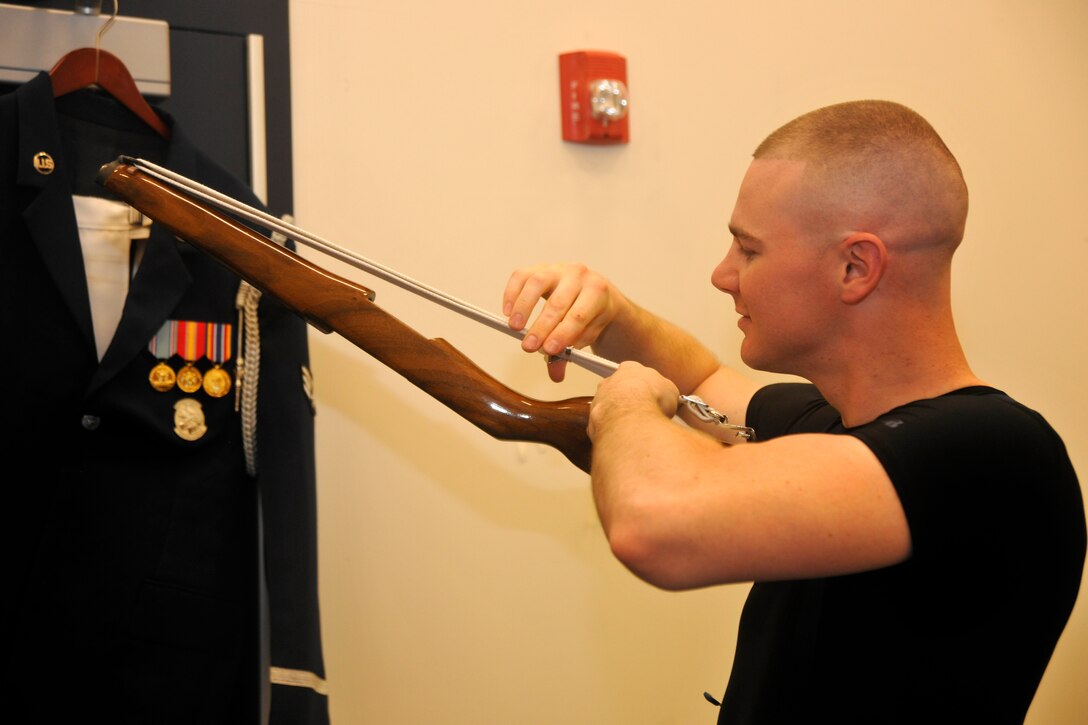 Staff Sgt. Andrew Winders, U.S. Air Force Honor Guard Drill Team member, prepares his rifle before a performance at Indian River High School in Virginia Beach, Va. April 19, 2013. The team performed in conjunction with a POW recognition ceremony given by the school’s AFJROTC unit. (U.S. Air Force photo/Senior Airman Lindsey A. Porter)
