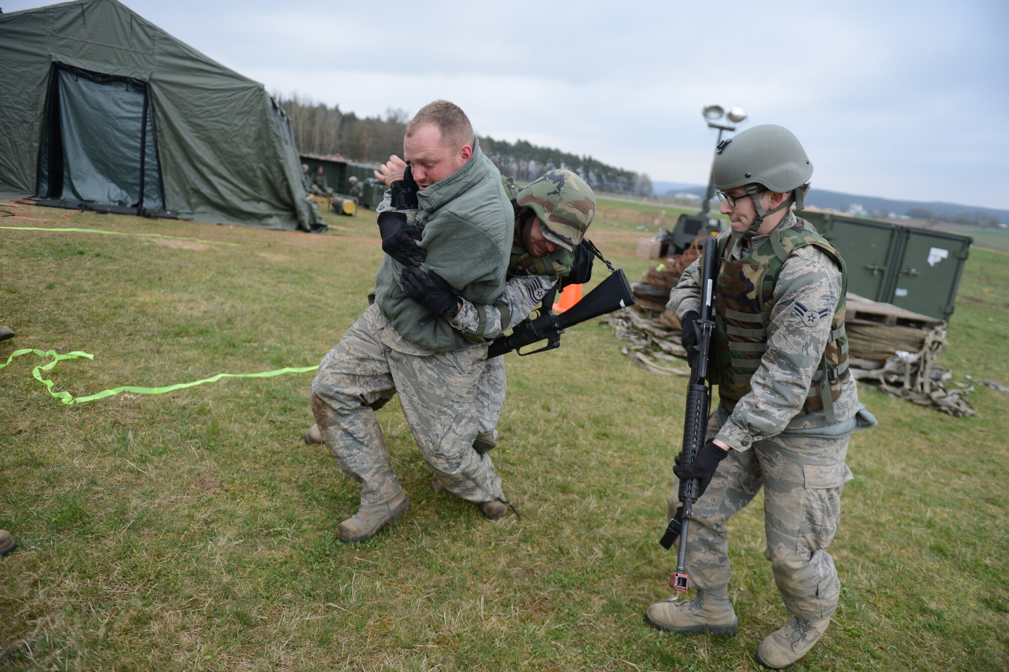 SPANGDAHLEM AIR BASE, Germany –U.S. Air Force Tech. Sgt. Nicholas Rowland, 606th Air Control Squadron radio frequency transmission technician from Fort Walton Beach, Fla., tackles U.S. Air Force Staff Sgt. Tyler O’Mally, 606th vehicle maintenance technician from Houston, to the ground during a combat readiness training course April 20, 2013. Skills taught during CRT directly apply to operations down range and help Airmen learn how to react to real-world scenarios in a controlled environment. (U.S. Air Force photo by Airman 1st Class Gustavo Castillo/Released)