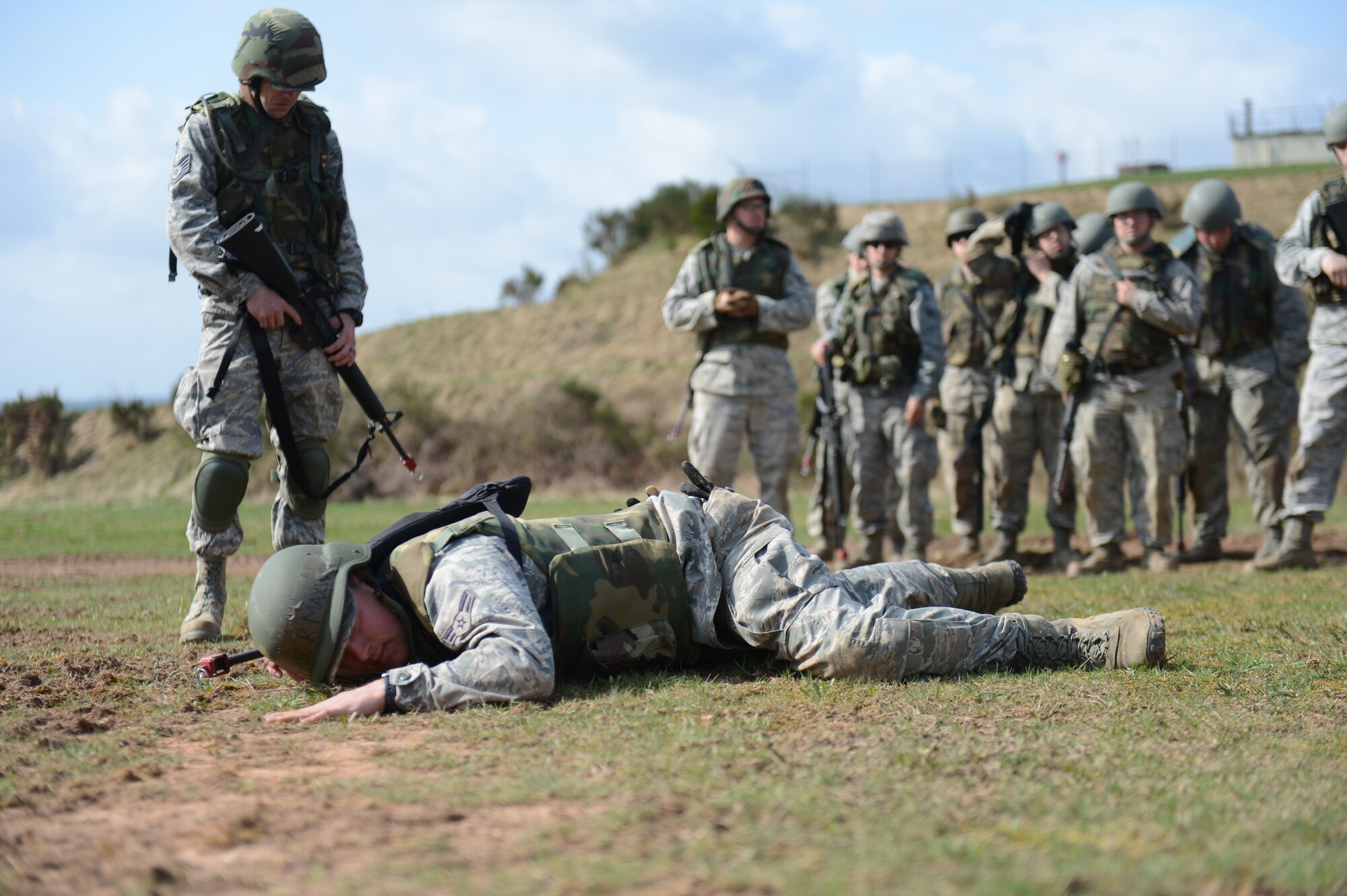 SPANGDAHLEM AIR BASE, Germany – U.S. Air Force Airman 1st Class Ryan Maxwell, 606th Air Control Squadron material management technician from Yorktown, Va., demonstrates the low-crawl technique at a combat readiness training course April 18, 2013. Those who graduate CRT become experts in deployment planning and implementation, weapons handling, preventive medicine, personal hygiene, site security, Law of Armed Conflict, use of force, enemy prisoners of war handling and counter improvised explosive device principles. (U.S. Air Force photo by Airman 1st Class Gustavo Castillo/Released)