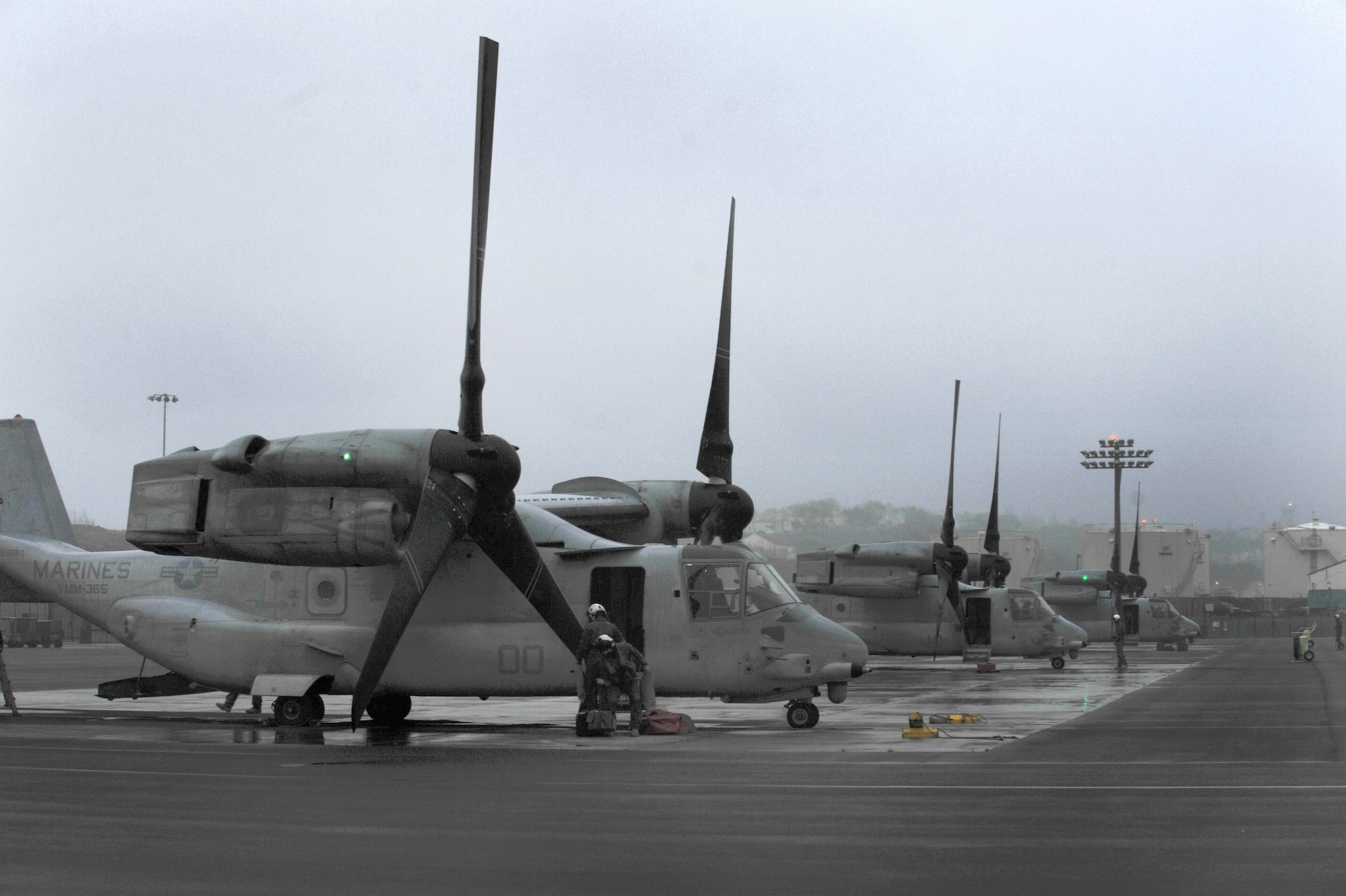 Members of the Marine Medium Tiltrotor Squadron 365 (VMM-365) and Marine Aerial Refueler Transport Squadron 252 stopped at Lajes Field during a transatlantic mission in support of a special Marine Air Ground Task Force-Crisis Response April 25. The crews are on their way to Moron, Spain, from Marine Corps Air Station New River, N.C., and MCAS Cherry Point, N.C.   Before their arrival, the 65th Operations Squadron coronet liaison, Tech. Sgt. Luke Adams, was their first point of contact at Lajes Field, as he is for all U.S. and foreign fighter and refueling aircraft coming through, to and from Lajes.  (U.S. Air Force photo by Staff Sgt. Angelique N. Smythe/released)