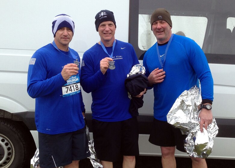 From left, U.S. Army Command Sgt. Maj. Matt Barnes; Chief Master Sgt. Gregory Warren, 100th Operations Group chief; and Chief Master Sgt. William Markham, 352nd Special Operations Group command chief, display their medals after running the 2013 Rock-n-Roll Half-Marathon in Edinburgh, Scotland. Several Airmen competed in the 13.1-mile event battling heavy winds, near-freezing temperatures and pelting rain.  (Courtesy photo/Released)