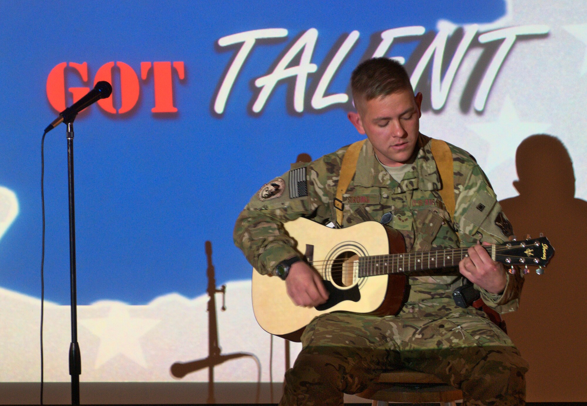 Airman First Class Jason Strong, 361st Expeditionary Reconnaissance Squadron, performs a song he wrote for the Kandahar’s Got Talent competition at Kandahar Air Field April 24. Strong, who has been at Kandahar for less than a week, placed second in the competition. (U.S. Air Force photo by Capt. Brian Maguire)