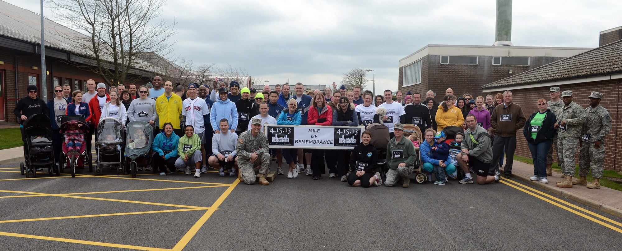 RAF MENWITH HILL, United Kingdom – Members of the Menwith Hill Station community pose for a group photo before the start of the “Boston Mile,” a mile of remembrance, which was held April 22 in order to honor and show support to the victims of the Boston Marathon bombing April 15. Roughly 80 people from around base joined together to run or walk in remembrance. (U.S. Air Force photo by Staff Sgt. Debbie Lockhart)