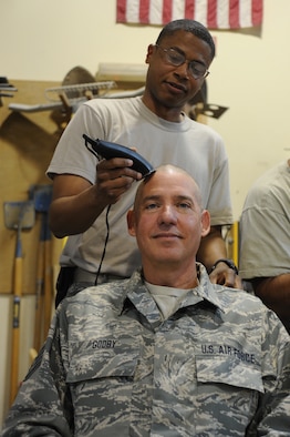 Staff Sgt. Gary Godby, 386th Expeditionary Civil Engineering Squadron has his head shaved by Staff Sgt. John Ewing at the 386th Air Expeditionary Wing, Southwest Asia Apr 25, 2013. Staff Sgt Gary Godby, 386th Expeditionary Civil Engineering Squadron organized the event to show his support for Noah and his family during his battle with cancer. (U.S. Air Force photo by Senior Master Sgt. George Thompson)