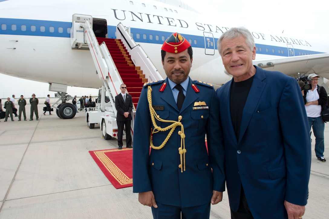 U.S. Defense Secretary Chuck Hagel, right, poses for a photos with his United Arab Emirates escort officer Col. Abdullah Hadmer al-Amani, left, departing Abu Dhabi, United Arab Emirates, April 25, 2013. 