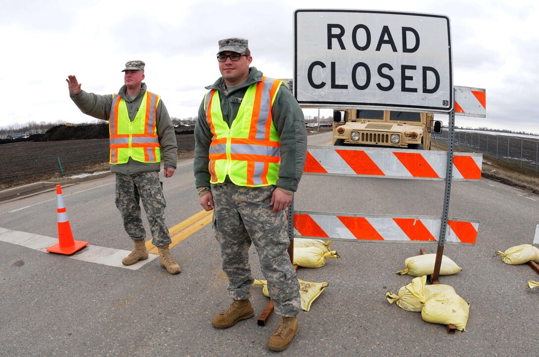 U.S. Army Spc. Bryan Sholts, left, and Spc. Alex Preszler man a traffic control point in anticipation of flooding along the Red River in Fargo, N.D., April 22, 2013. Both are assigned to the 191st Military Police Company, North Dakota Army National Guard. 