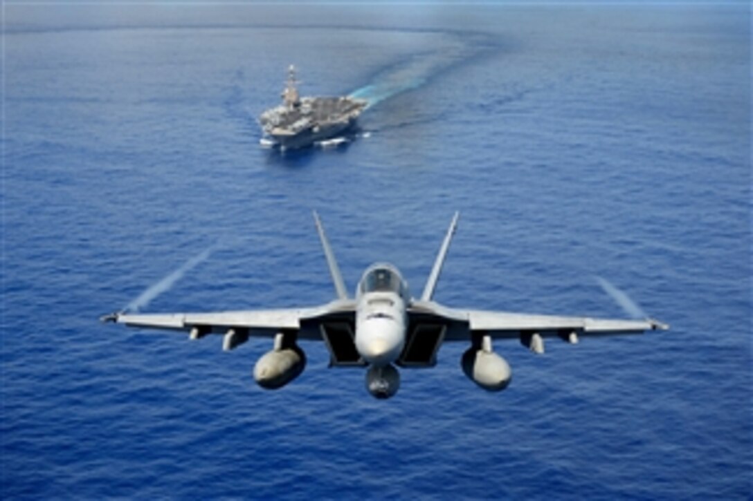 An F/A-18E Super Hornet participates in an air power demonstration near the aircraft carrier USS John C. Stennis (CVN 74) as the ship operates in the Pacific Ocean on April 24, 2013.  The John C. Stennis Carrier Strike Group is returning from an eight-month deployment to the U.S. 5th and 7th Fleet areas of responsibility.  The Super Hornet is attached to Strike Fighter Squadron 14.  