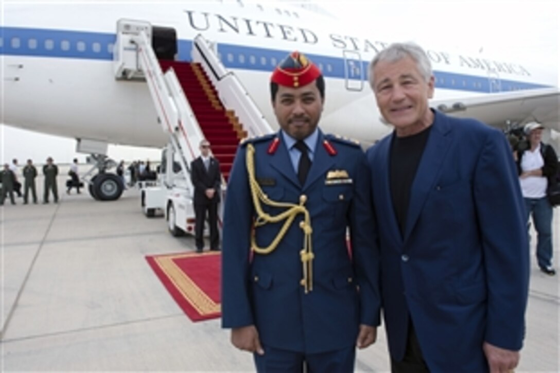 U.S. Defense Secretary Chuck Hagel poses for a photo with his escort officer, United Arab Emirates Col. Abdullah Hadmer al-Amani, departing Abu Dhabi, United Arab Emirates, April 25, 2013. Hagel met with defense leaders on his last stop on a six-day trip to the region. 