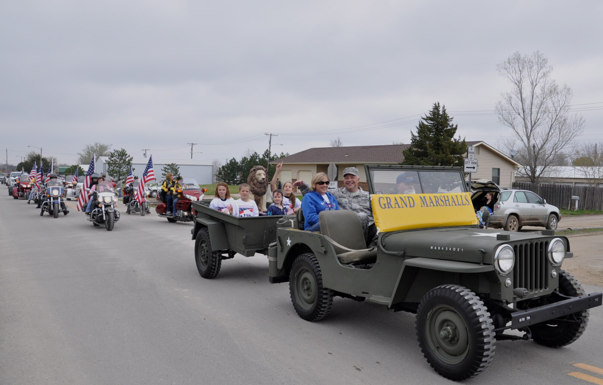 Chief Master Sgt. Paul R. McGinnis, the Maintenance Group Superintendent in the Deputy Commander for Maintenance Staff, 931st Air Refueling Group, and his wife Lynelle, ride in the Grand Marshall's vehicle during the annual Parade Day parade in Benton, Kansas, April 27. The residents of Benton invited McGinnis to serve as Grand Marshall for the parade. (Official Air Force photo by Master Sgt. Brannen Parrish)