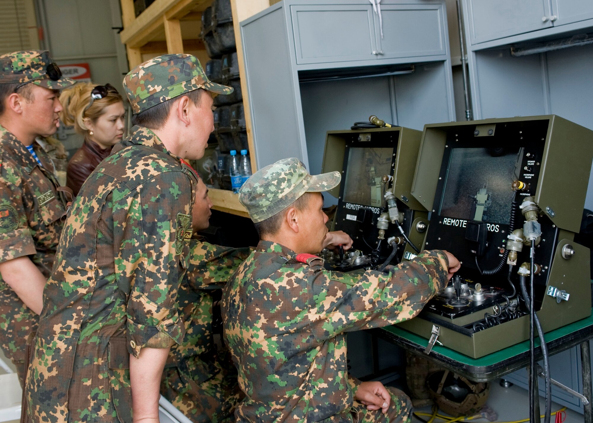 Kyrgyz Republic explosive ordnance disposal team members control a bomb disposal robot during an EOD military exchange April 23, 2013, at Transit Center at Manas, Kyrgyzstan.  During a week-long military exchange, members from U.S. Armed Forces and Kyrgyz Republic Ministry of Defense were able to exchange EOD knowledge and procedures. (U.S Air Force photo/Staff Sgt. Stephanie Rubi)