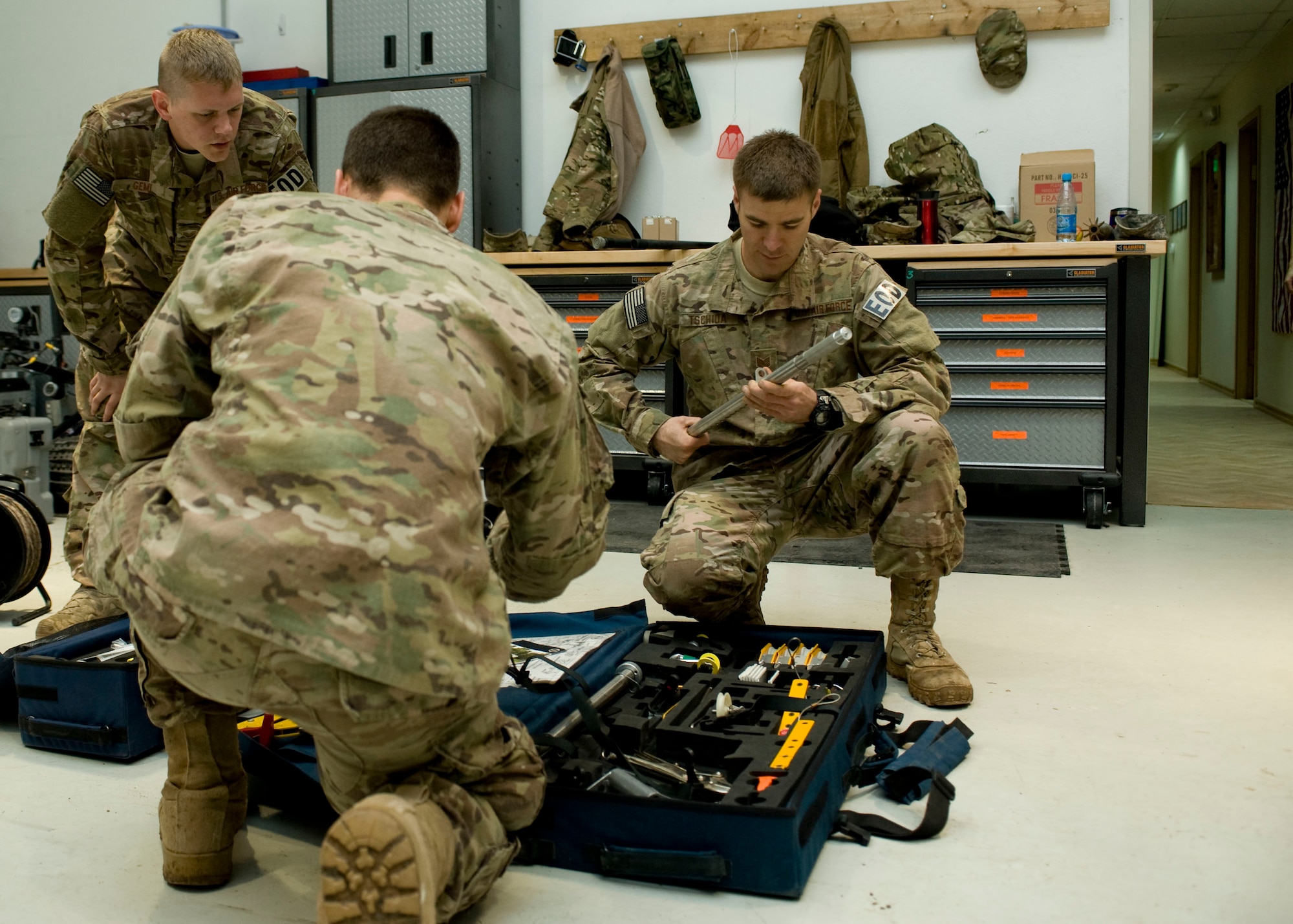 Airmen from the 376th Expeditionary Civil Engineer Squadron explosive ordnance disposal team, assemble a hook and line kit during an EOD military exchange April, 24, 2013, at Transit Center at Manas, Kyrgyzstan. EOD Airmen use the kit to remove objects from areas where explosives could be located while maintaining a safe distance from the explosives. (U.S Air Force photo/Staff Sgt. Stephanie Rubi)