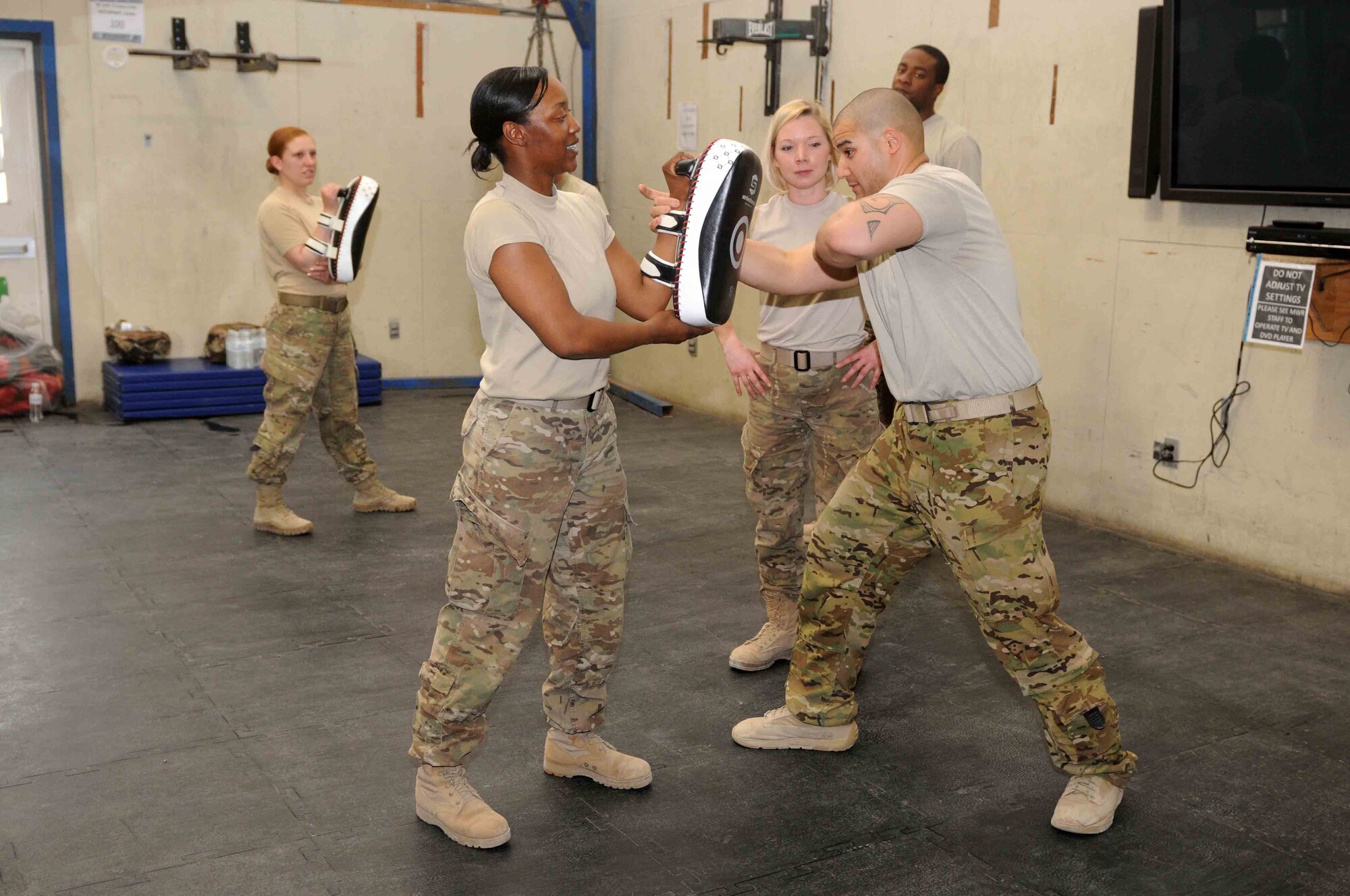 Tech Sgt. Eric Bergery Jr., 451st Expeditionary Security Forces Squadron senior combatives instructor, demonstrates punching techniques during a self-defense class April 9, at Kandahar Airfield, Afghanistan. (U.S. Army photo by Sgt. Lacey J. Hunt)