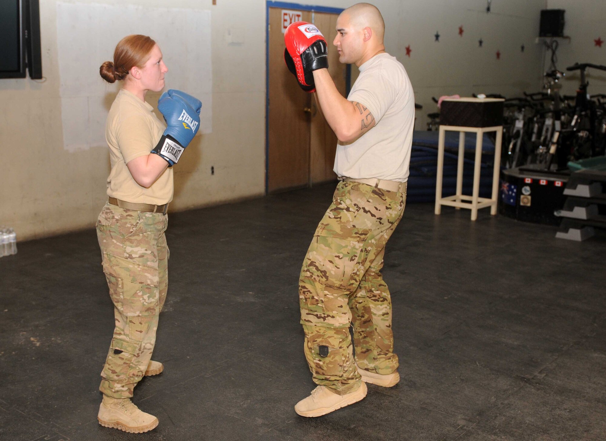 Senior Airmen Bambi White, a flyway security team member in the Air Force, and Tech Sgt. Eric Bergery Jr., the senior combatives instructor, practice punching techniques during a self-defense class April 9, at Kandahar Airfield, Afghanistan. (U.S. Army photo by Sgt. Lacey J. Hunt)