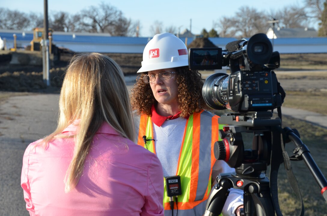 Terri Stamm, St. Paul District safety specialist, discusses the safety aspect of the construction of the temporary levee along 2nd Street during an interview with KVLY-TV in Fargo on April 26. Safety covers a broad area, ranging from public safety, to construction crew safety to equipment safety. The emergency levee is being built to help protect the city from flooding due to the rising Red River of the North. This is the fourth time in the past five years that the Corps has supported the city’s flood fight. USACE photo by Patrick Moes