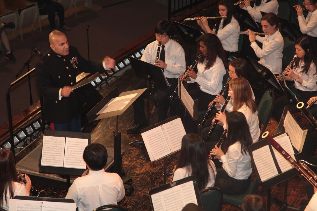 Chief Warrant Officer Stephen B. Giove directs a song during the 2013 DODEA Pacific Far East Honor Music Festival concert at Kubasaki High School on Camp Foster April 19. Members of the III Marine Expeditionary Force Band collaborated with students from DODEA Pacific high schools to help advance the students’ musical abilities. The festival featured an orchestra and choir performance, and involved DODEA Pacific participants from Guam, Korea, Okinawa and mainland Japan. Giove is the director of the III Marine Expeditionary Force Band. 