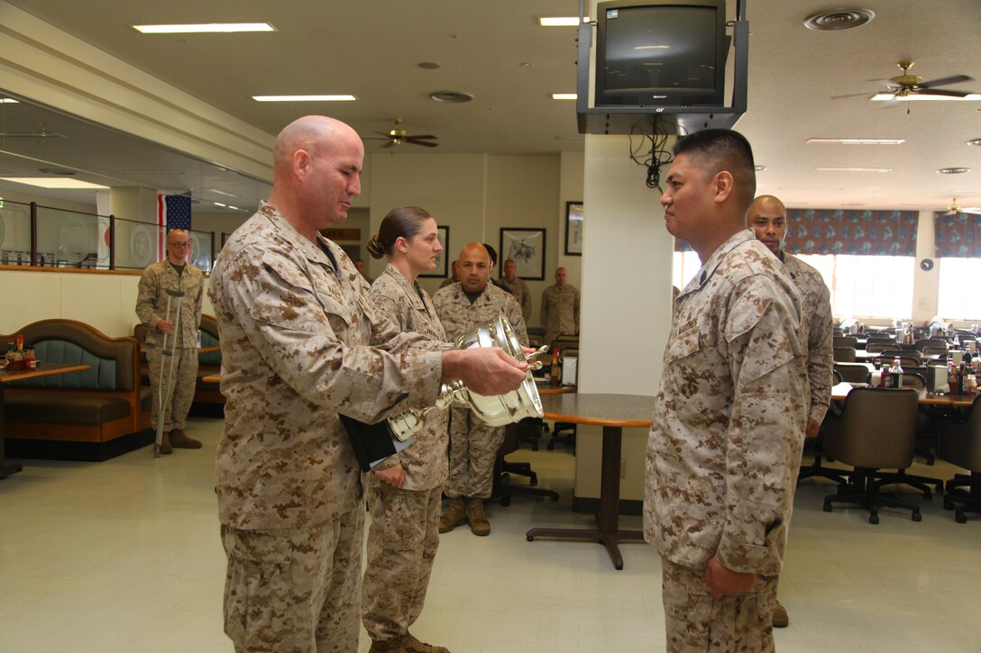 Col. Richard D. Hall, left, presents Master Sgt. Vichien Sornchan with a trophy April 24 at Camp Schwab for him and his Marines’ efforts in earning honors as large mess hall of the quarter for the second quarter of fiscal year 2013. As of the second quarter of FY 2013, mess halls are now separated into two categories for the competition. To win large mess hall of the quarter, a mess hall has to be able to seat more than 400 people. “This is a tough and demanding job which requires long hours of work, but these Marines continue to perform it with professionalism and pride,” said Hall, the commanding officer of 4th Marine Regiment, 3rd Marine Division, III Marine Expeditionary Force, and Camp Schwab commander. Sornchan is the Camp Schwab mess hall manager with Headquarters Company, 4th Marines.