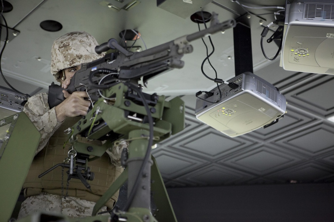Pfc. Zagros Dawoudi provides security for a 7-ton truck at the III Marine Expeditionary Force motor vehicle simulator facility April 23 at Camp Hansen. Marines and sailors with III Marine Expeditionary Force and Marine Corps Installations Pacific learned about various training devices available to them on Okinawa during the III MEF combat camera training device expo April 18 at Camp Hansen. Dawoudi is a motor transport operator with Combat Logistics Regiment 35, 3rd Marine Logistics Group, III Marine Expeditionary Force. 