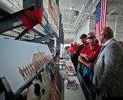 Airmen and civilians check out the displays prior to the retirement ceremony for the MC-130E Combat Talon I at Duke Field, Fla., April 25.  Aircrew, maintainers and many others turned out to remember and bid farewell to the Talon I on its official retirement from the Air Force.  The last five Talons, located at Duke Field, will be delivered to the “boneyard” at Davis-Monthan Air Force Base, N.M., by mid-May 2013.  (U.S. Air Force photo/Tech. Sgt. Samuel King Jr.)