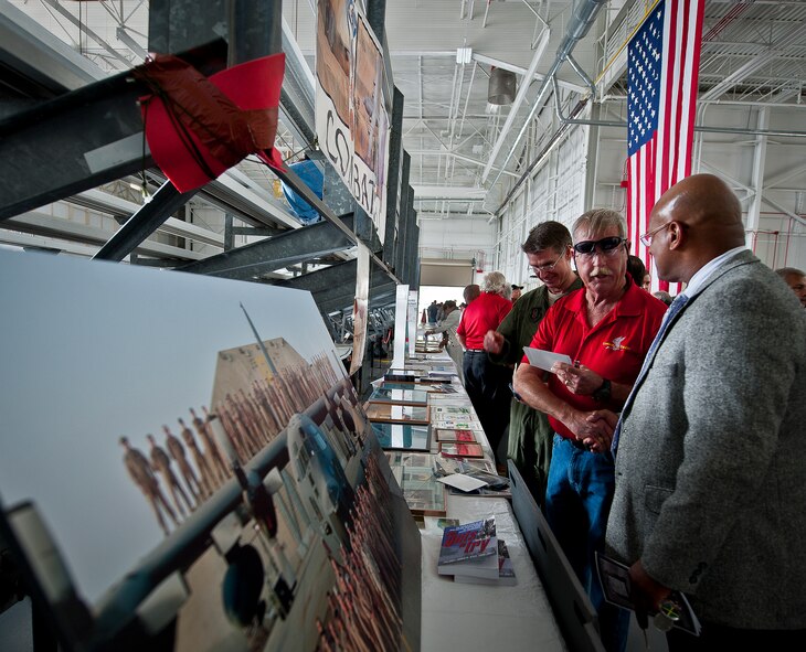Airmen and civilians check out the displays prior to the retirement ceremony for the MC-130E Combat Talon I at Duke Field, Fla., April 25.  Aircrew, maintainers and many others turned out to remember and bid farewell to the Talon I on its official retirement from the Air Force.  The last five Talons, located at Duke Field, will be delivered to the “boneyard” at Davis-Monthan Air Force Base, N.M., by mid-May 2013.  (U.S. Air Force photo/Tech. Sgt. Samuel King Jr.)