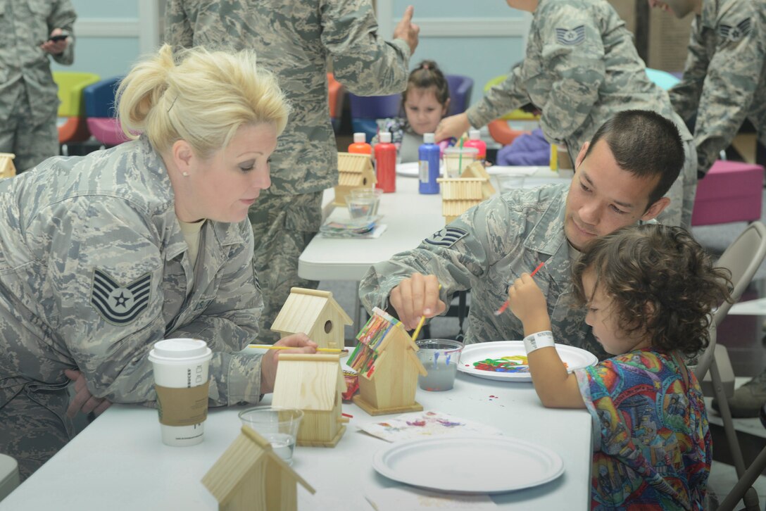 Members of the 136th Airlift Wing, Texas Air National Guard visit children at the Cook Children's Health Care System, Fort Worth, Texas, to spend time with special-needs children, April 27, 2013. The children were invited to paint bird houses for fun as a distraction from their hospital visit. (Air National Guard photo by Master Sgt. Charles Hatton/Released) 