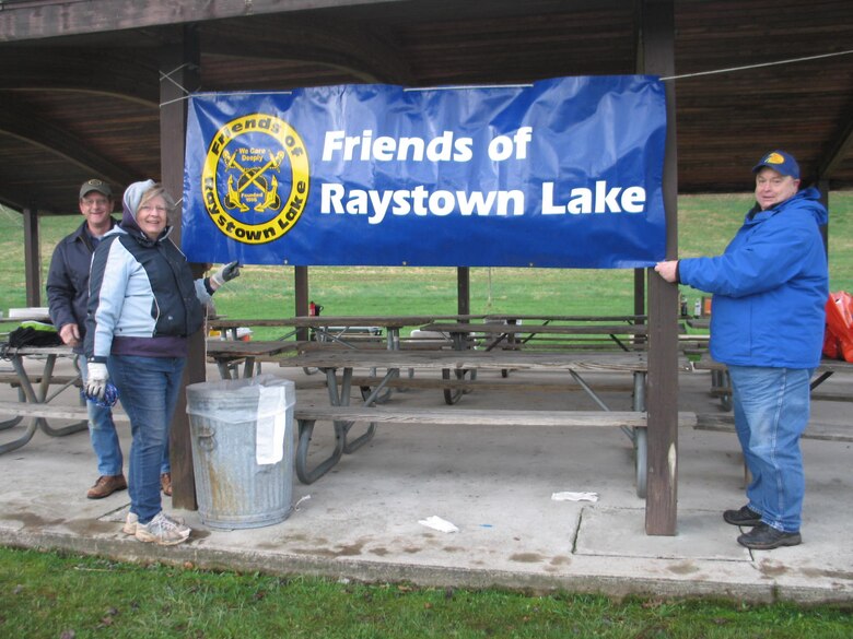 Friends of Raystown Lake members hang a banner to celebrate Lake Cleanup Day.