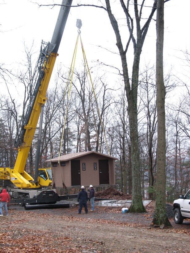 Maintenance employees install a new restroom in Susquehannock Campground near site 34.