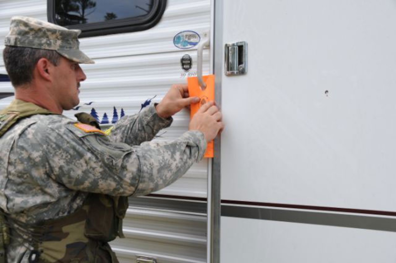 Specialist Robert Wilson, of Pontotoc Miss., leaves a flyer on a FEMA travel trailer in Gulfport during notification operations in preparation for the landfall of Hurricane Gustav. Wilson is a member of the Pontotoc-based A Troop, 1st Battalion, 98th Cavalry Regiment, Mississippi Army National Guard. More than 2,500 members of the Mississippi National Guard are on state active duty, assisting civil authorities in preparing the Mississippi Gulf Coast.