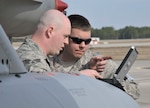 TYNDALL AIR FORCE BASE, Fla. - Maintainers from the 179th Fighter Squadron, a subordinate unit of the 148th Fighter Wing out of Duluth, Minn., review technical data prior to preparing an aircrew for a mission at Tyndall Air Force Base, Fla., Jan. 27. The 148th FW is working with the 53rd Weapons Evaluation Group at Tyndall AFB for two weeks to train for their Air Sovereignty Alert missions and to validate their new Block 50 F-16s. 

(U.S. Air Force photo by Tech. Sgt. John Hoffmann) 

