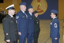 ST. JEAN SUR RICHLIEU, Quebec – U.S. Air Force Technical Sergeants Clifford Fallico (second from left), Air Forces Northern intelligence, surveillance and reconnaissance planner, and Robert Carnall, 702nd Computer Support Squadron System Administrator (third from left), stand before Chief Master Sgt. Angela Abshire (right), director of standards at the Noncommissioned Member Professional Development Center, at the graduation ceremony where they both earned the “Comradeship Award” from the Canadian Intermediate Leadership Program, Canadian Forces College, Noncommissioned Member Professional Development Center, St. Jean Sur Richlieu in Quebec, Canada. Only four of 120 students received the peer-voted award. 

(Photo by Christian Jaques)

