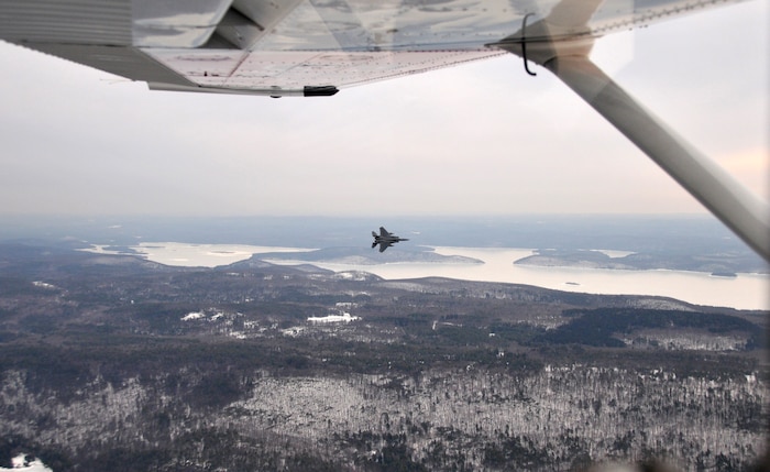 An F-15 from the 104th Fighter Wing of the Massachusetts Air National Guard is seen outside the window of a Civil Air Patrol aircraft during an intercept training mission over the White Mountains in New Hampshire March 2, 2011. Civil Air Patrol helps Aerospace Control Alert units train for scrambles and intercepts by providing a track of interest. 

