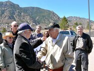 CHEYENNE MOUNTAIN AIR FORCE STATION, Colo. - Retired U.S. Air Force Master Sgt. John Mutu, front row center with black ball cap, is surprised for his 90th birthday April 4 on Cheyenne Mountain Air Force Station by 25 former colleagues and family members. The group, which worked together in the Communication Squadron, shared stories of the "good old days," toured the air station and noted some of the remarkable changes to their former workstation. Mr. Mutu's former colleagues, who came from Colorado, Texas, and Ohio, worked on CMAFS during the 1970s. Mr. Mutu had a long distinguished career in the U.S. Air Force, but said some of his most fond memories were of working in a special place like CMAFS. 

(U.S. Air Force photo by Lt. Daniel Taylor) 

