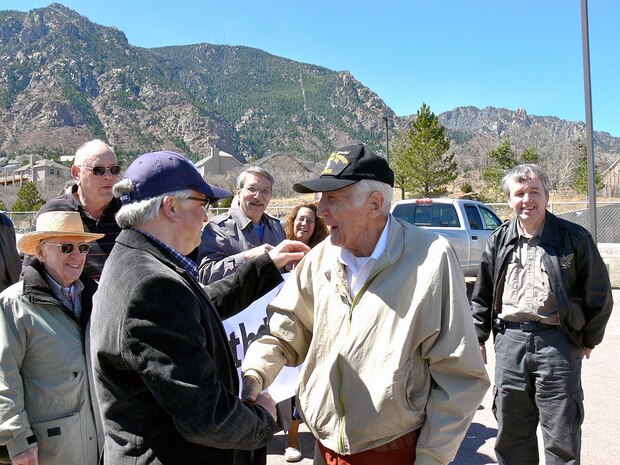 CHEYENNE MOUNTAIN AIR FORCE STATION, Colo. - Retired U.S. Air Force Master Sgt. John Mutu, front row center with black ball cap, is surprised for his 90th birthday April 4 on Cheyenne Mountain Air Force Station by 25 former colleagues and family members. The group, which worked together in the Communication Squadron, shared stories of the "good old days," toured the air station and noted some of the remarkable changes to their former workstation. Mr. Mutu's former colleagues, who came from Colorado, Texas, and Ohio, worked on CMAFS during the 1970s. Mr. Mutu had a long distinguished career in the U.S. Air Force, but said some of his most fond memories were of working in a special place like CMAFS. 

(U.S. Air Force photo by Lt. Daniel Taylor) 


