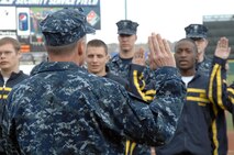 COLORADO SPRINGS, Colo. - Navy Adm. James Winnefeld, North American Aerospace Defense Command and U.S. Northern Command commander, gives the oath of enlistment to 12 U.S. Navy enlistees at the Sky Sox - Grizzlies game at Security Services Field May 3. The Admiral was also invited to throw out the first pitch. 

(U.S. Air Force photo by Tech. Sgt. Thomas J. Doscher) 

