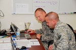 Lt. Col. Philip Parker of Summit, Miss., and Lt. Col. Charles Rhoads of Byram, Miss., monitor information for the Rear Emergency Operations Center, which kept track of the various missions conducted by the Mississippi National Guard on the Gulf Coast prior to landfall of Hurricane Gustav on Sept. 1.