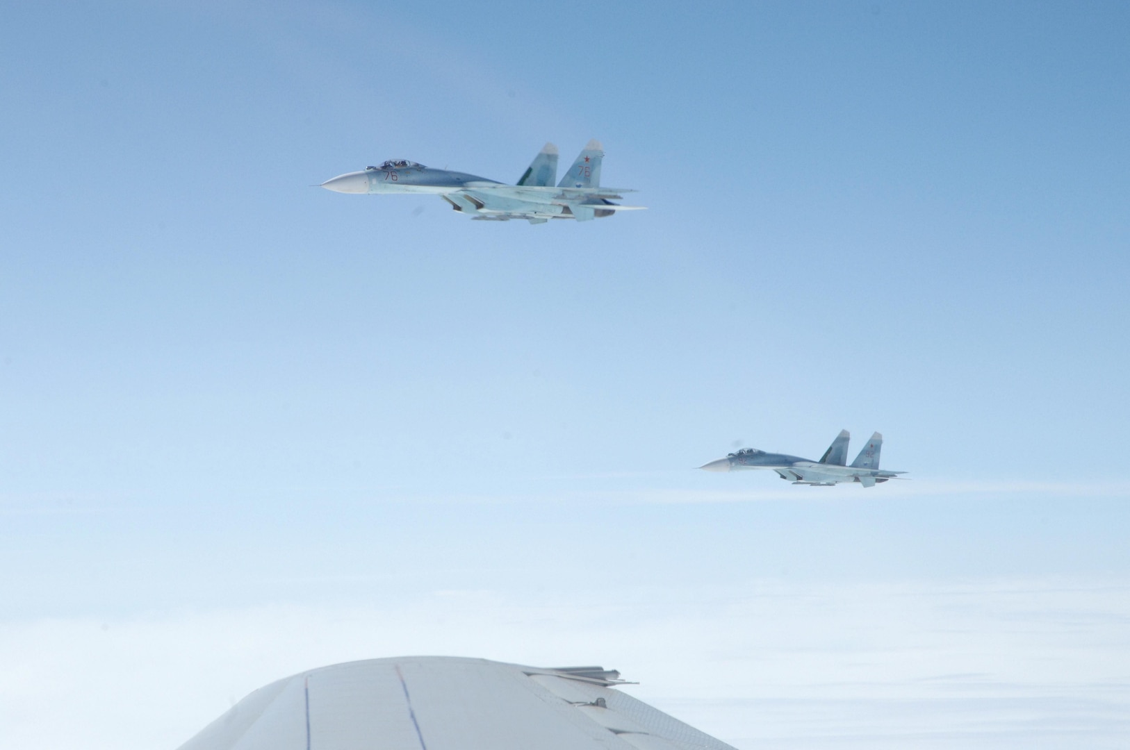 OVER THE PACIFIC OCEAN – A pair of SU-27 fighters escorts a simulated hijacked airliner during the second day of flying for Exercise Vigilant Eagle Aug. 9, 2011. The Russian fighters followed and monitored the aircraft while it was in Russian airspace, handing it over to U.S. F-15 fighters from Elmendorf Air Force Base, Alaska, when it entered U.S. airspace. (U.S. Air Force photo by Tech. Sgt. Thomas J. Doscher)

