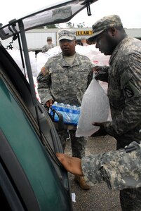 Mississippi Army National Guardsmen load up a vehicle with bottled water and ice for a Gulfport, Miss., resident Sept. 2, 2008, just outside the city. Citizens began returning home after Hurricane Gustav caused most of the region to evacuate to safer areas.