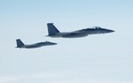 OVER THE PACIFIC OCEAN – A pair of U.S. F-15 fighters take up an escort position for a simulated hijacked airliner flying toward U.S. airspace during the second day of flying for Exercise Vigilant Eagle Aug. 9, 2011. The fighters took over the escort from a pair of Russian SU-27 fighters once the airliner, a Russian Federation Air Force jet, left Russian airspace and entered U.S. airspace. F-15 Eagles and SU-27 fighters escorted the aircraft while E-3 and A-50 airborne warning and control aircraft monitored them. (U.S. Air Force photo by Tech. Sgt. Thomas J. Doscher)
