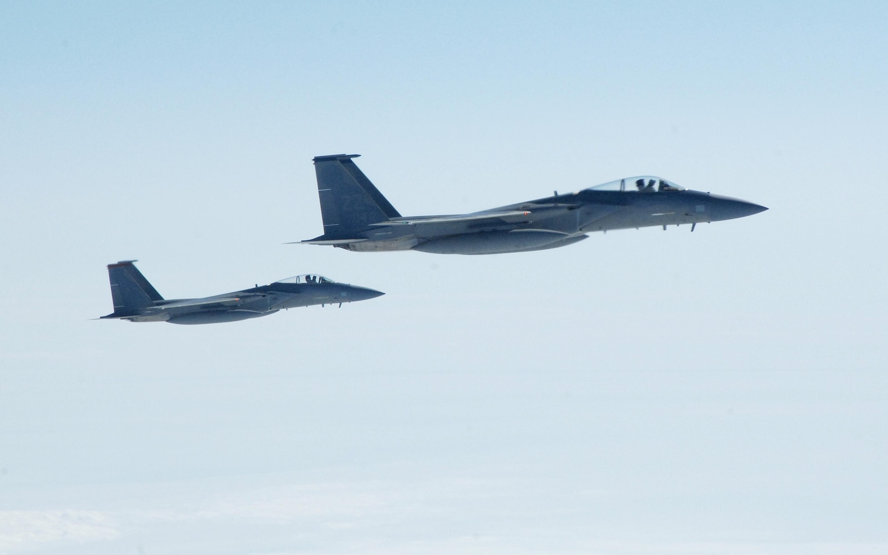 OVER THE PACIFIC OCEAN – A pair of U.S. F-15 fighters take up an escort position for a simulated hijacked airliner flying toward U.S. airspace during the second day of flying for Exercise Vigilant Eagle Aug. 9, 2011. The fighters took over the escort from a pair of Russian SU-27 fighters once the airliner, a Russian Federation Air Force jet, left Russian airspace and entered U.S. airspace. F-15 Eagles and SU-27 fighters escorted the aircraft while E-3 and A-50 airborne warning and control aircraft monitored them. (U.S. Air Force photo by Tech. Sgt. Thomas J. Doscher)
