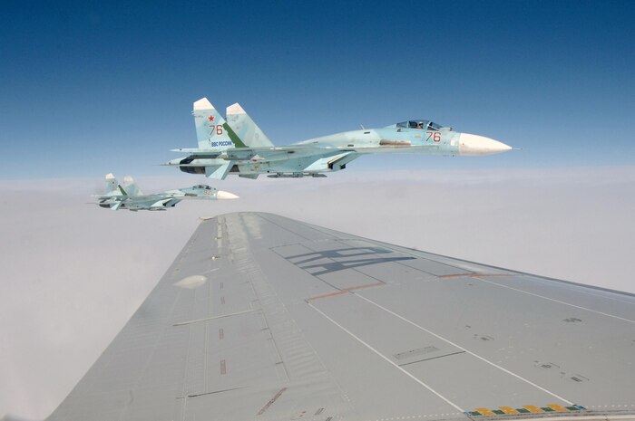 OVER THE PACIFIC OCEAN – A pair of SU-27 fighters escorts a simulated hijacked airliner during the second day of flying for Exercise Vigilant Eagle Aug. 9, 2011. The Russian fighters followed and monitored the aircraft while it was in Russian airspace, handing it over to U.S. F-15 fighters from Elmendorf Air Force Base, Alaska, when it entered U.S. airspace. (U.S. Air Force photo by Tech. Sgt. Thomas J. Doscher)
